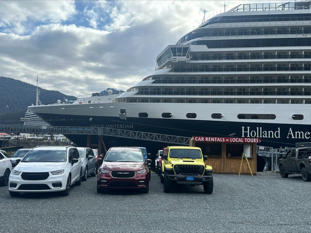 Explore Juneau rental vehicles parked beside a cruise ship at the Juneau docks